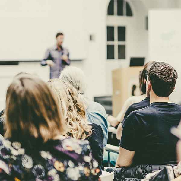 People listening to a presentation at a conference.