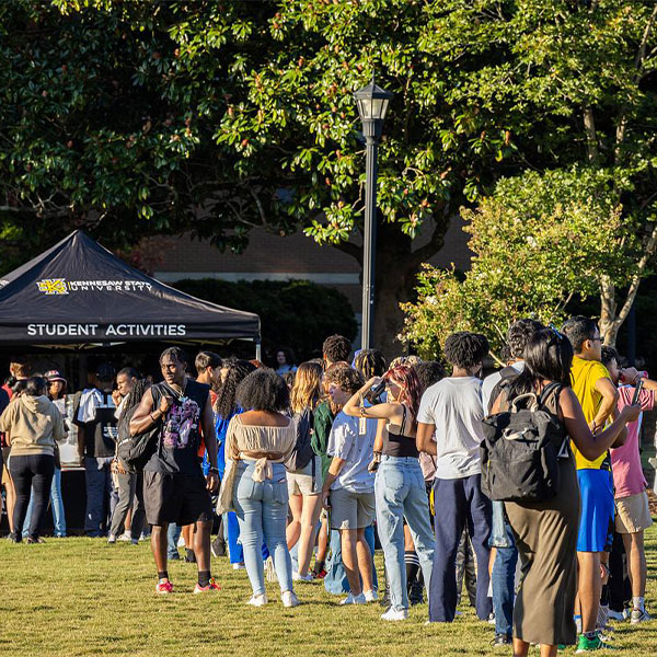 large group of ksu students waiting in line for the student activities tent.