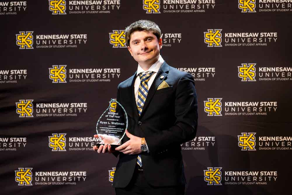 Ryan Waltman poses with his Student Leader of the Year Award