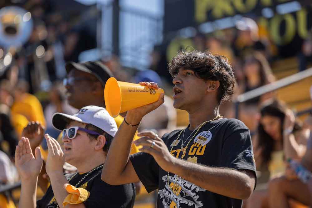 Students cheering at the KSU football game.