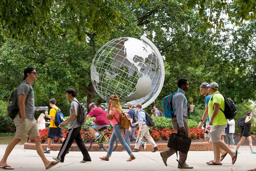 KSU students walking on Marietta Campus by the globe.