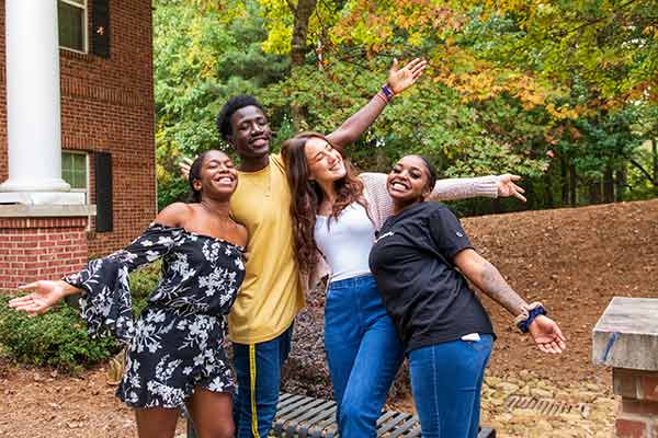 ksu students posing together in front of dorm