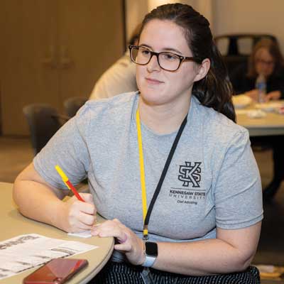 ksu student sitting at desk taking notes