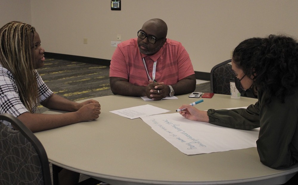 conference attendees having conversation at table