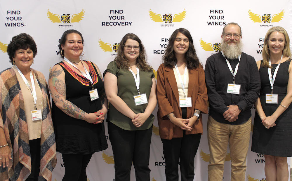 staff posing together at Advancing Connections for Recovery event