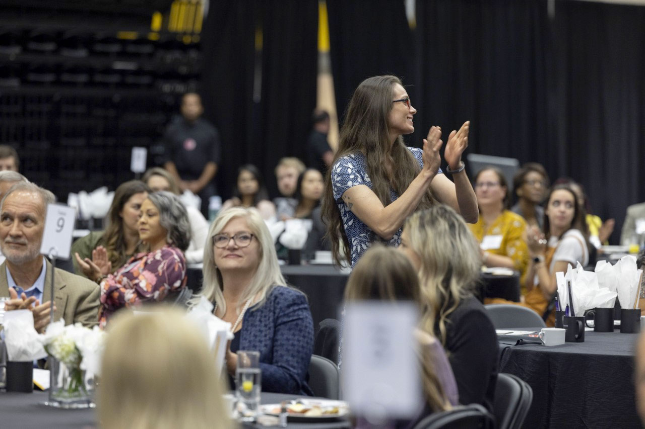 woman celebrating at Collegiate Recovery Scholarship Breakfast event