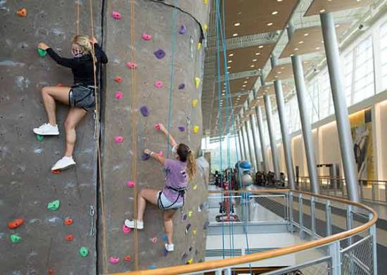 ksu student wall climbing in indoor facility