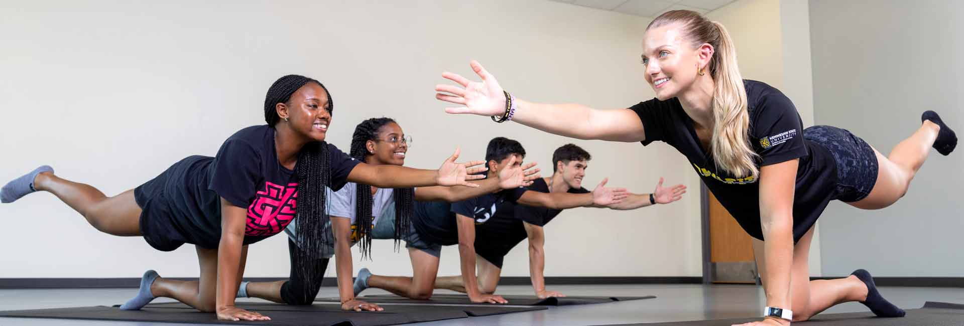 ksu students working out together on mat