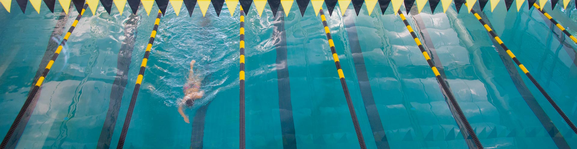 ksu student swimming laps in indoor pool