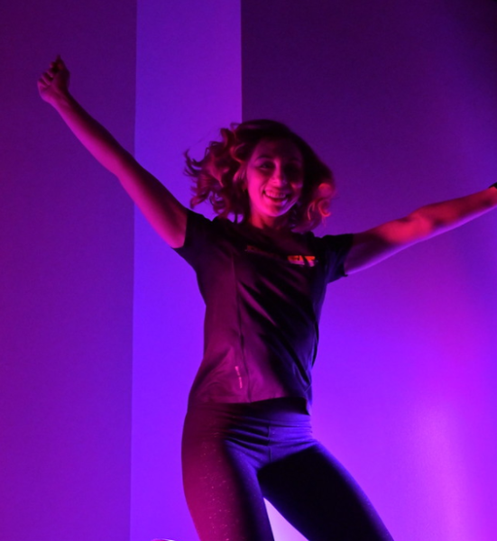 ksu student working out in glow in dark fitness class