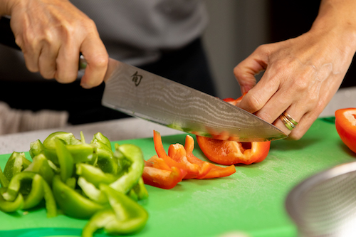 close up knife cutting vegetables