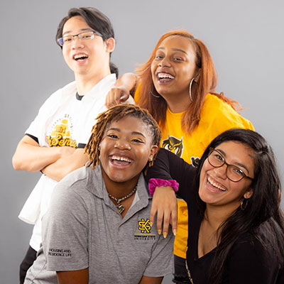 group of four ksu students smiling