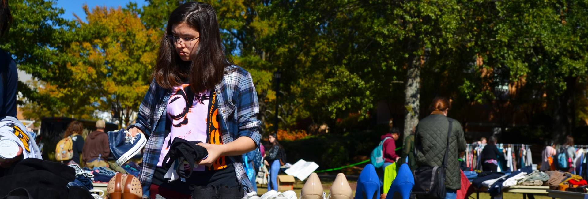 A student picking out shoes at an OwlSwap event