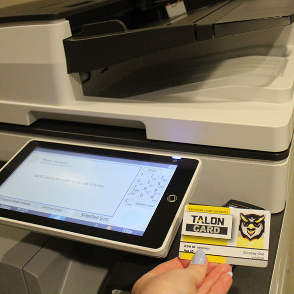 Student using their Talon Card to print on campus