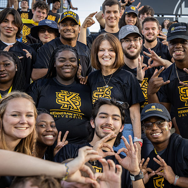 Students enjoying game day with President Schwaig