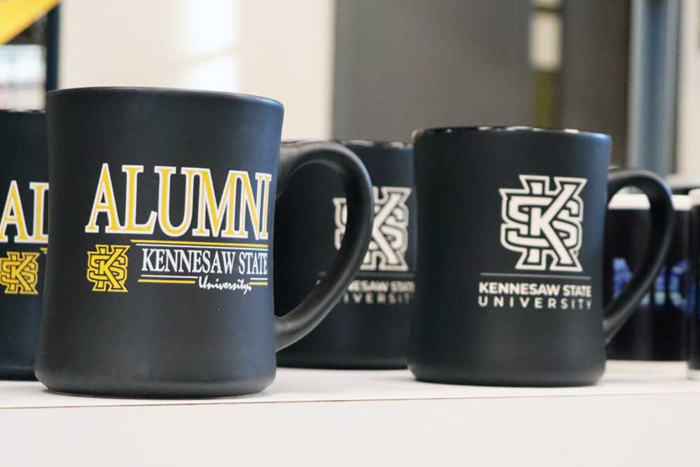 offical ksu alumni coffee mugs sitting on table