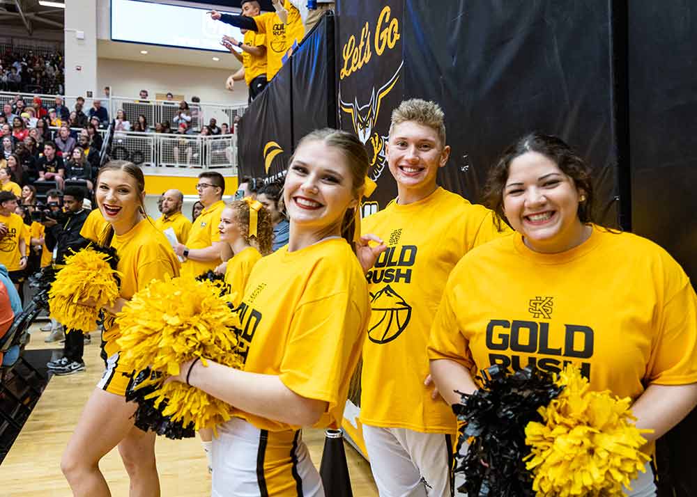 cheer group wearing official ksu gear