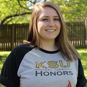 KSU Female smiling with KSU tshirt