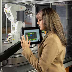 ksu student at control panel for robotic arm