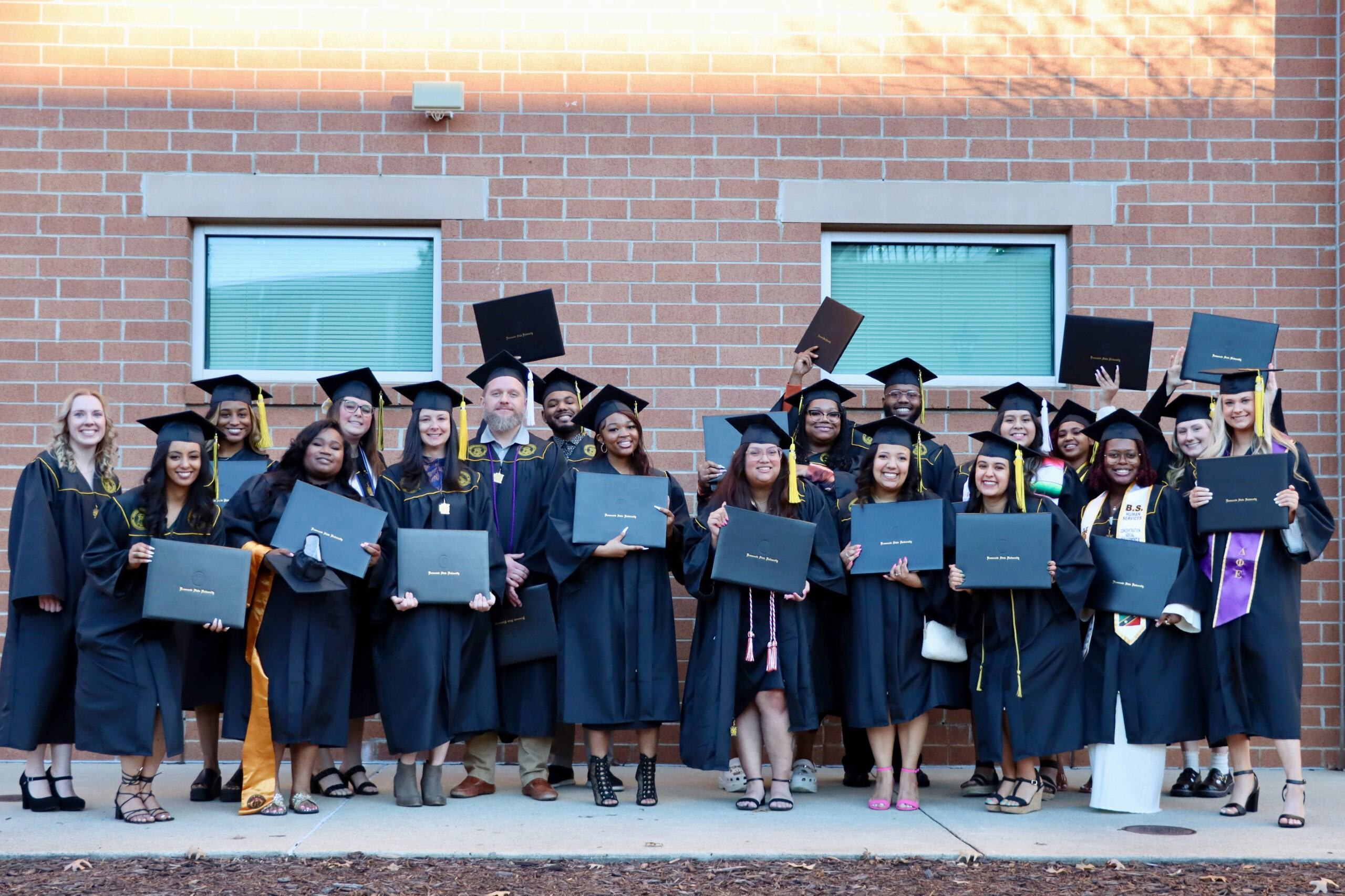 MSW graduates posing with professors