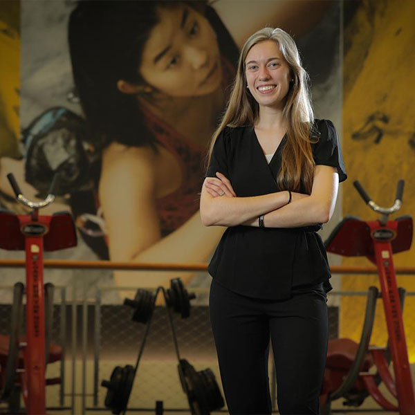 ksu student in a workout gym smiling for picture