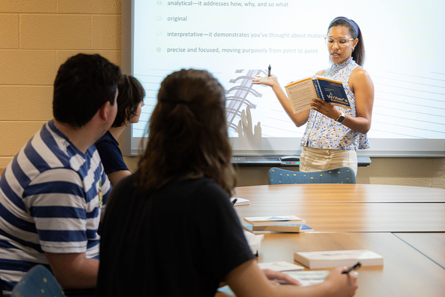 faculty tutoring group of students in the writing center.