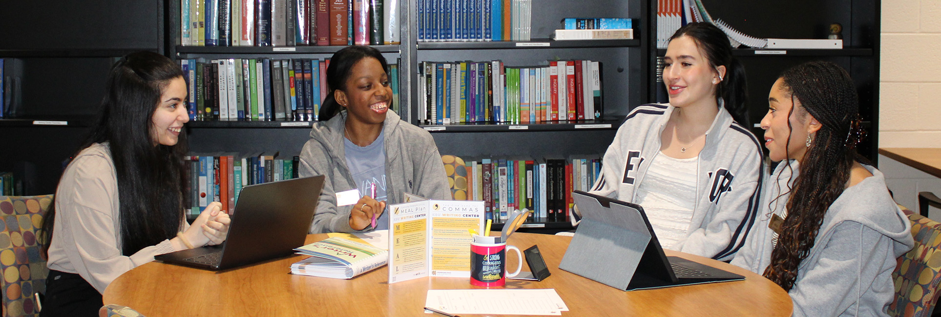 group of students sitting at the writing center