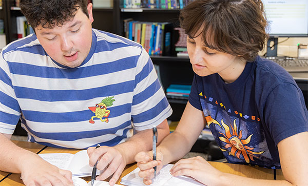 A photo of a student and a writing center, writing assistant